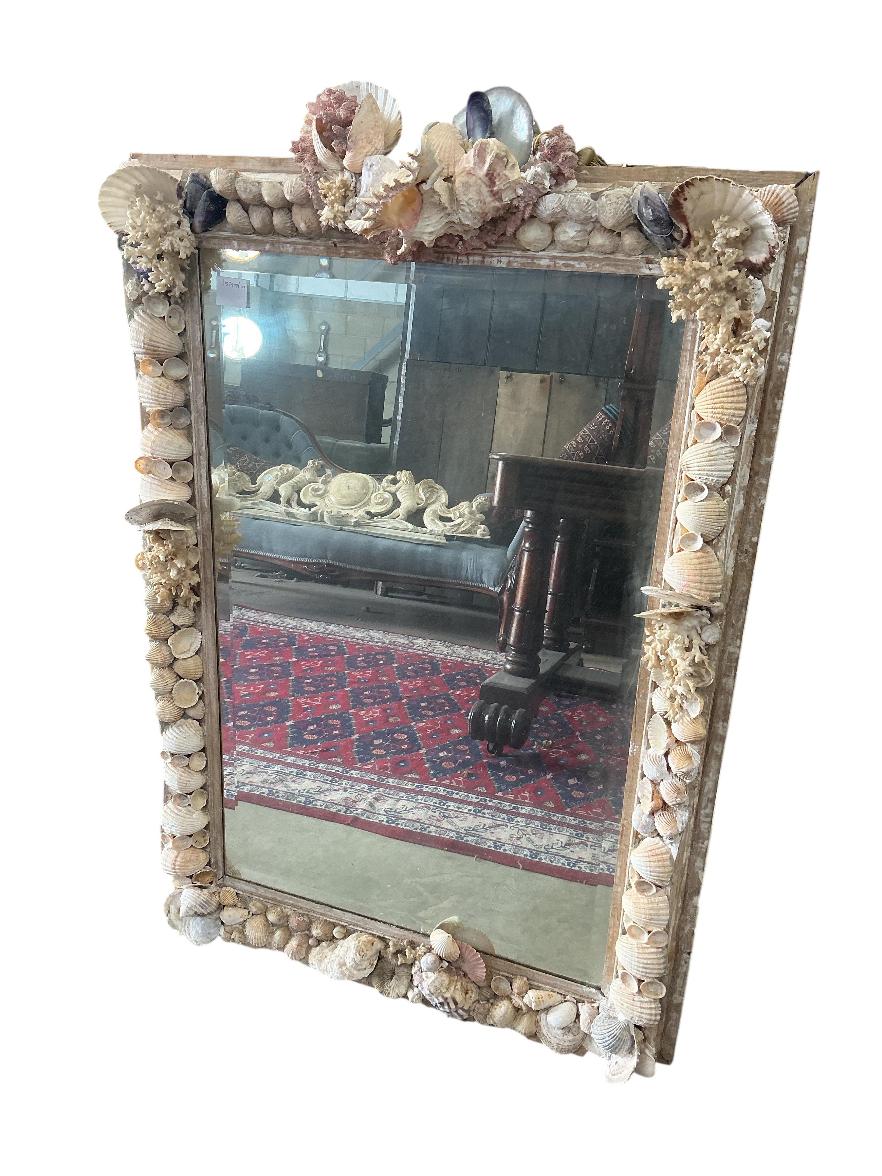 A rectangular shell encrusted wall mirror, width 77cm, height 114cm